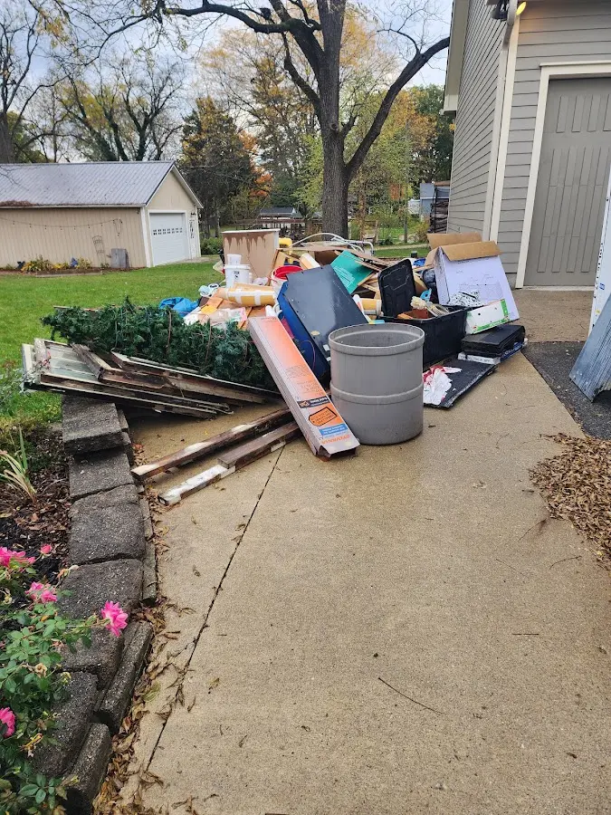 Dumpster being loaded with debris for Roofing Dumpster Rental in Sullivan